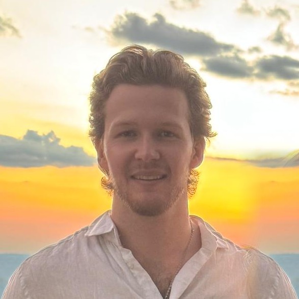 Headshot of Nic Defaux — Senior Software Engineer and Technical Strategist — backlit by a golden sunset that lends this site its warm accent colour
